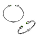 Handcrafted silver cuff bracelet with peridot quartz ends and garnet quartz accents in Bali design.